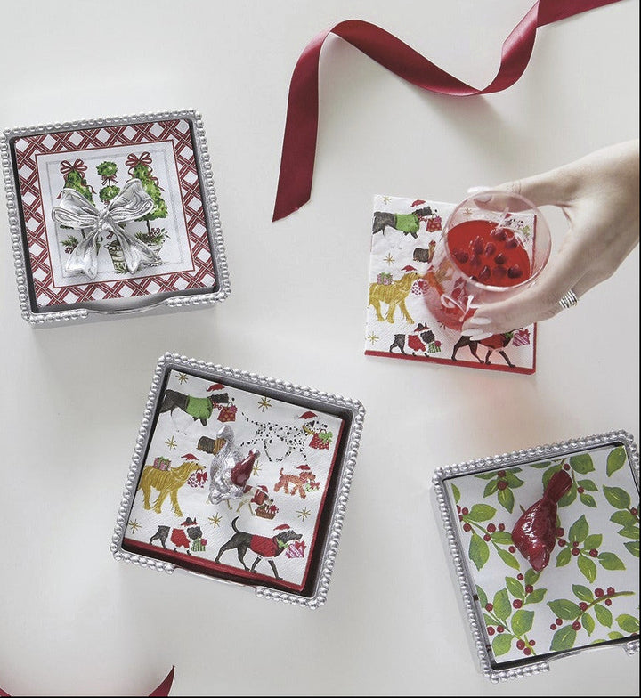 Set of Christmas-themed gift boxes with decorative ribbons on a white surface